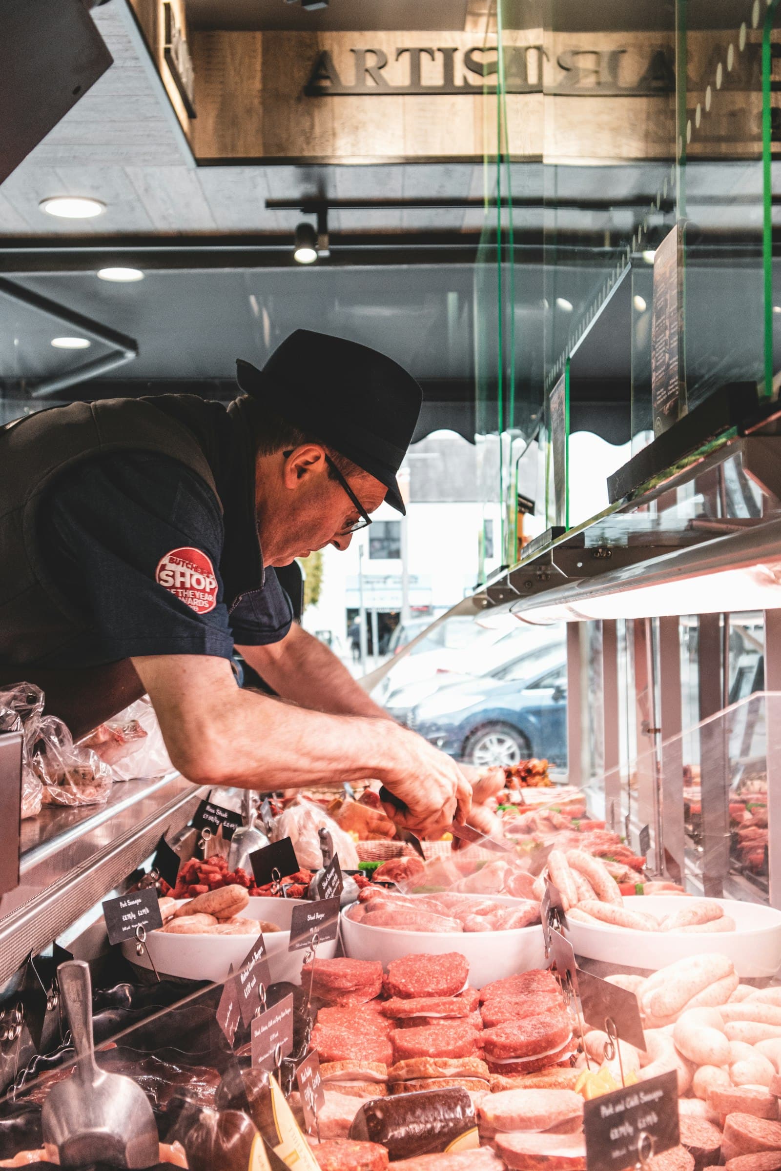 A butcher at work behind the counter