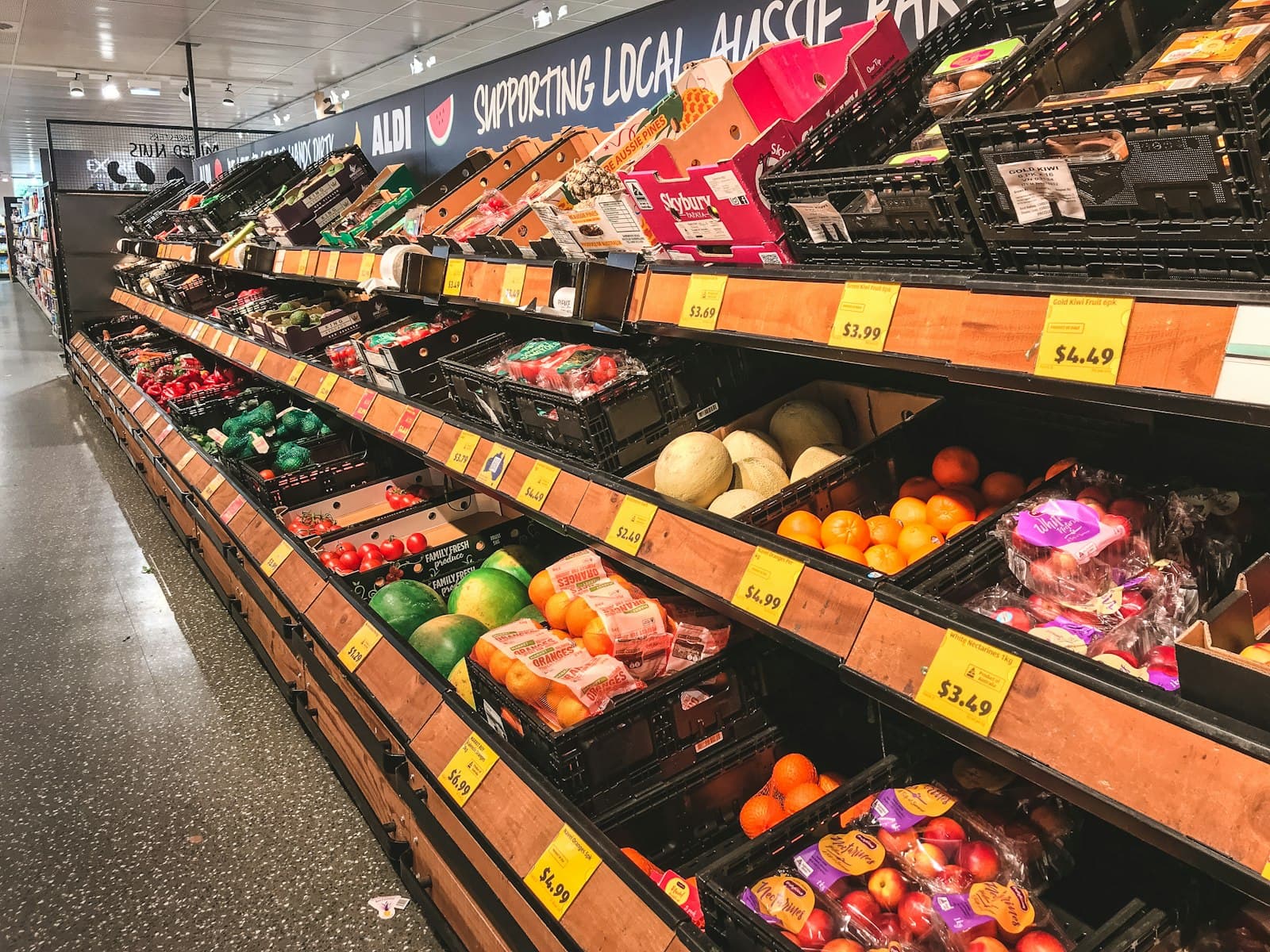 Fruit arranged on market shelving