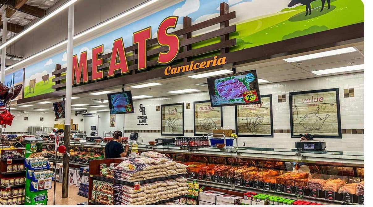A supermarket meat counter under Carnicería signage